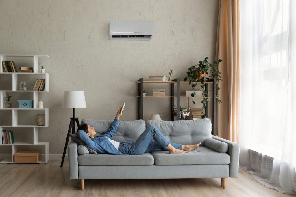 Woman relaxing on a couch in a professionally cleaned living room